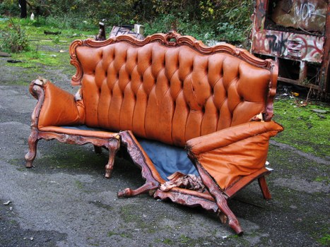 Workers standing by commercial waste containers with high-visibility vests