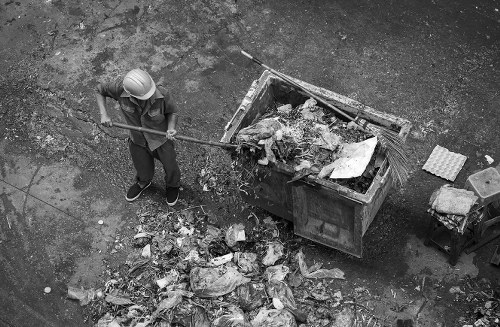 Construction site with builders clearing waste in Bayswater